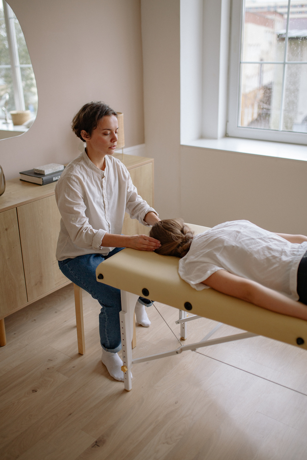 A Therapist Massaging a Woman's Head